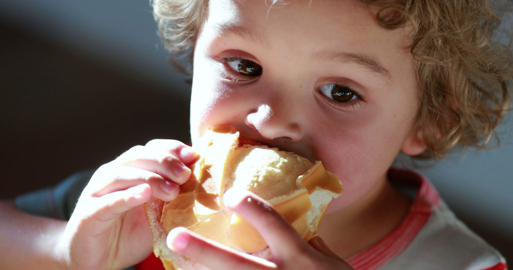 Young boy eating a healthy lunch