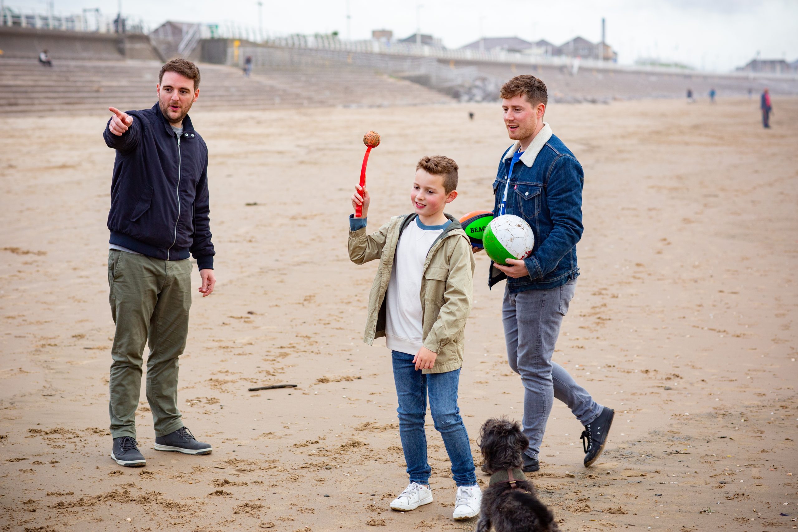 Two men and a boy playing ball
